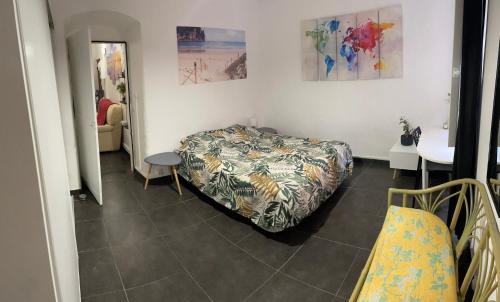 a bedroom with a bed and a table and a mirror at [ Hébergement partagé à proximité de la place du marché à Bastia ] in Bastia