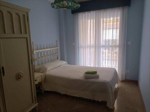 ein Schlafzimmer mit einem weißen Bett und einem Fenster in der Unterkunft apartamento céntrico en Lorca in Lorca
