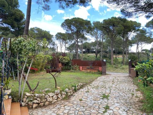 a path in a garden with a fence and trees at L'Encís Begur - Casa unifamiliar con piscina, jardín y barbacoa in Begur