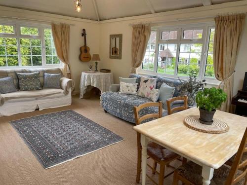 a living room with a couch and a table at Huntleys Lodge in Ticehurst
