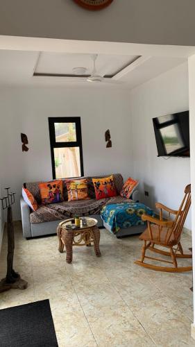 a living room with a couch and a table at Cuckoo's Nest in Tanji