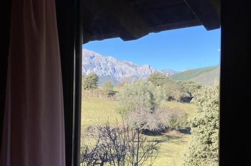 a window with a view of a mountain at Hotel Finca Malvasia - Adults only in Cabezón de Liébana