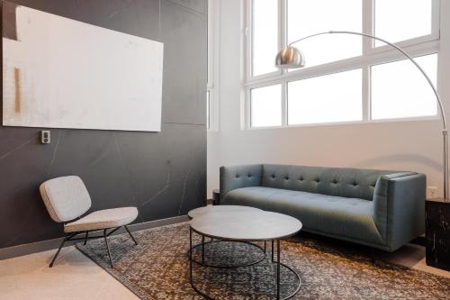 a living room with a couch and a table at Placemakr Navy Yard in Washington
