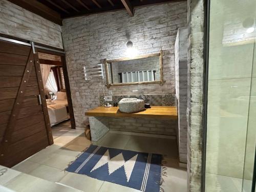 a bathroom with a sink and a mirror at Estalagem Wiesbaden in Monte Verde