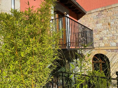 a balcony on the side of a building with trees at Hotel Finca Malvasia - Adults only in Cabezón de Liébana