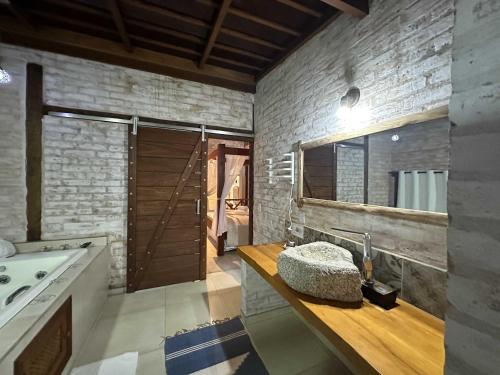 a bathroom with a sink and a large mirror at Estalagem Wiesbaden in Monte Verde