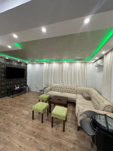 a living room with a couch and a flat screen tv at Kod Šmece apartmani - Valjevo in Valjevo