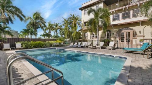 a swimming pool in front of a house at Crystal Bay Historic Hotel in St Petersburg