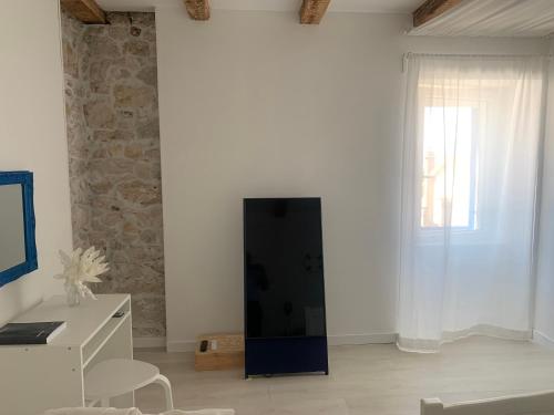 a living room with a black cabinet and a window at House Franulich in Stara Baška