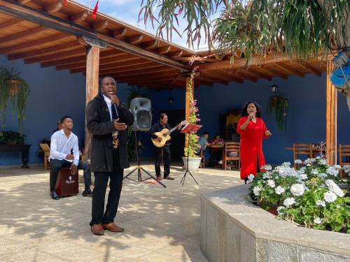 a man standing in front of a microphone next to a woman at Casa Hacienda San Jose in Chincha Alta
