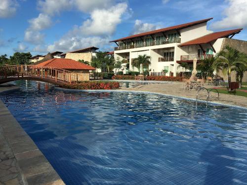 ein großes Schwimmbad vor einem Gebäude in der Unterkunft Club Meridional Carneiros in Tamandaré