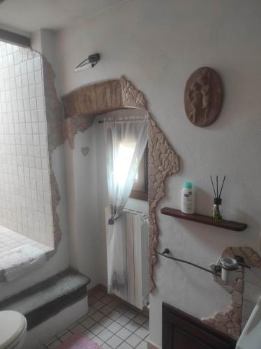 a bathroom with a shower and a sink and a mirror at Casa dei nonni 57021 in Campiglia Marittima