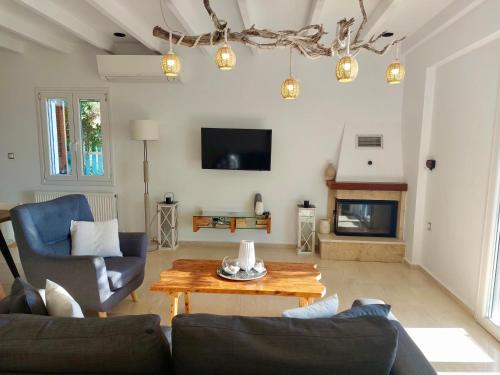 a living room with a couch and a table at Villa Tramonto in Lévki