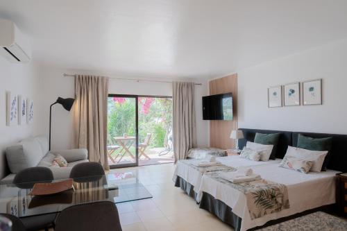pokój hotelowy z łóżkiem i salonem w obiekcie Seacoast Retreat, Beach Apartment by Drago Rentals w Albufeirze