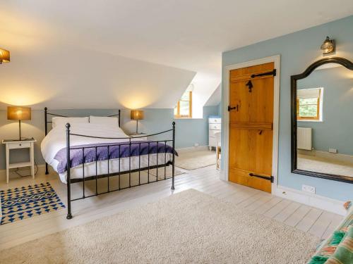 a bedroom with a bed and a large mirror at 3 Bed in Crickhowell 48309 