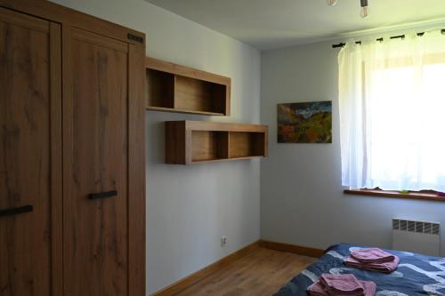 a bedroom with a bed and a window at Strażnica Pod Lasem in Lasowka