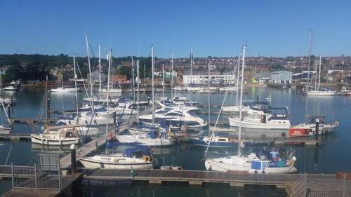 a bunch of boats docked in a harbor at Marina View South Facing Balcony Sunny Apartment in East Cowes