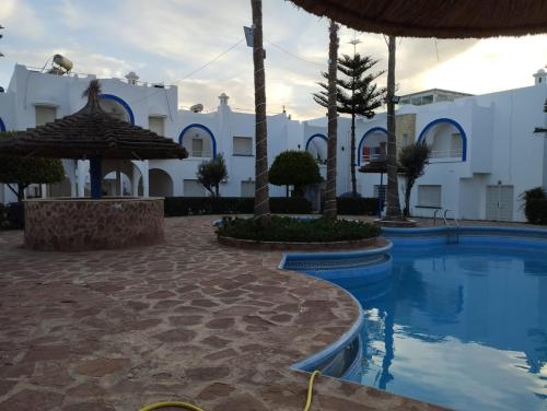 a resort with a swimming pool and a building at Naila in Sidi Bouzid