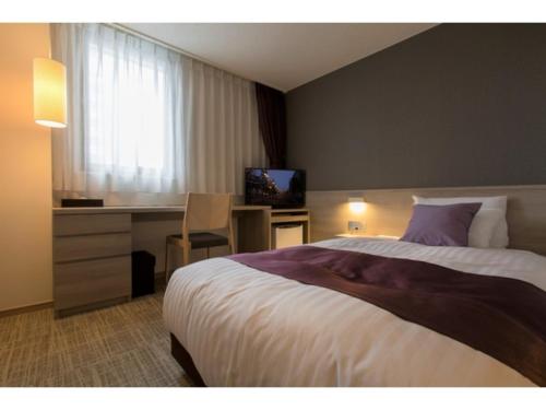 a hotel room with a bed and a desk and a television at KITA HOTEL - Vacation STAY 69750v in Morioka