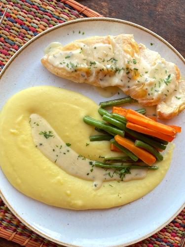 a plate of food with fish and vegetables on it at Casa Hacienda San Jose in Chincha Alta