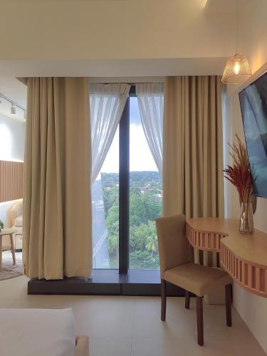 a room with a table and a chair and a window at Triann Condo Staycation Davao in Aeon Towers in Davao City