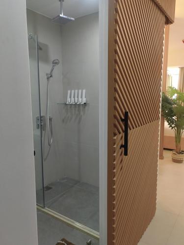 a bathroom with a shower with a glass door at Triann Condo Staycation Davao in Aeon Towers in Davao City