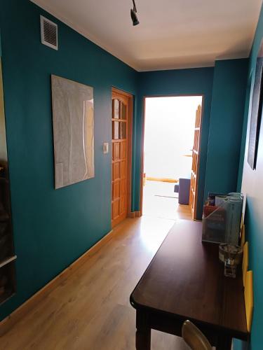 a room with a table and a blue wall at Strażnica Pod Lasem in Lasowka
