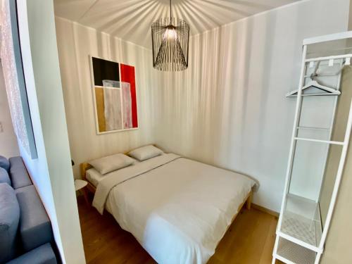 a small bedroom with a bed and a ladder at Cozy Residence Apartment - Tallinn City Center in Tallinn