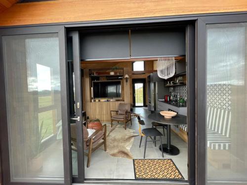 Soular Lodge e Fazenda في ساو فرانسيسكو دي باولا: غرفة معيشة مع طاولة وغرفة طعام