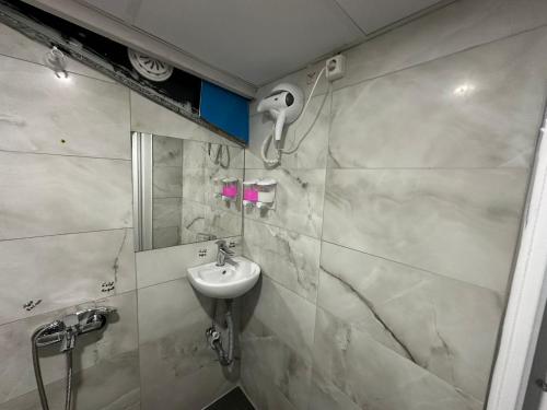 a bathroom with a sink and a shower at Nr1 Pansiyon in Canakkale