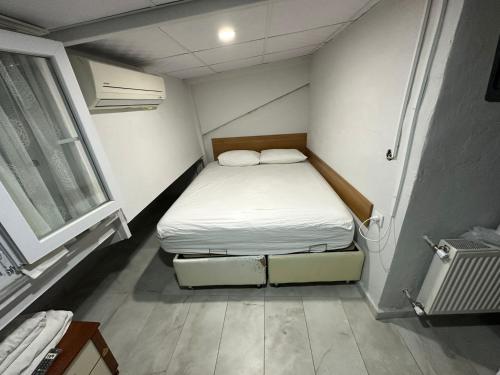 a small room with a bed and a window at Nr1 Pansiyon in Canakkale