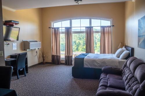 a hotel room with a bed and a window at Williamsport Grandview Hotel in Linden