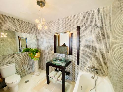 a bathroom with a sink and a toilet and a mirror at Bungalow Paraiso in Callao Salvaje