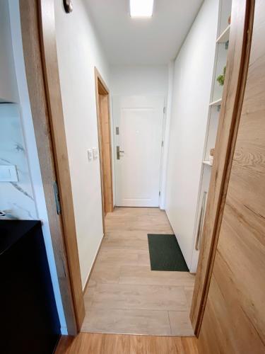 a hallway of an apartment with a door and a rug at Cozy Apartment Bovec in Bovec