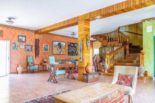 a living room with a table and a staircase at Taino Cove in Treasure Beach