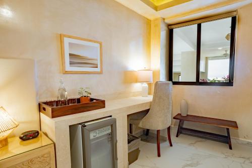 a room with a desk and a chair and a window at Casa Nawalli Puerto Vallarta Boutique Hotel - Adults Only in Puerto Vallarta