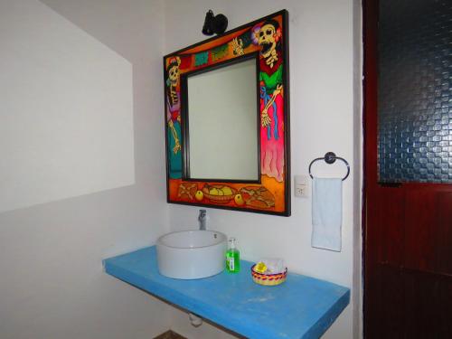 a bathroom with a sink and a mirror at Hotel Villas Ponto Holbox in Holbox Island
