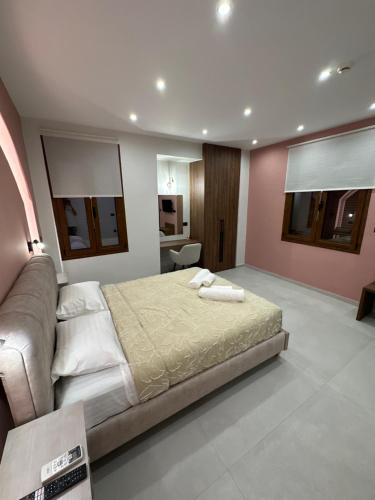 a bedroom with a bed in a room with pink walls at Incanto Luxury Suites 2 in Nafpaktos