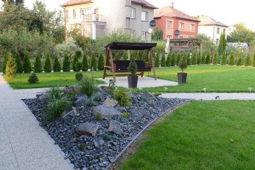 a garden with a swing in a yard at Apartman Ostrava in Ostrava