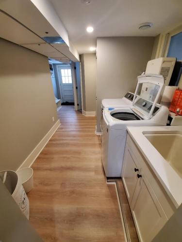 a hospital hallway with a washing machine and a sink at Cheerful 3-bedroom in Wayzata on private wooded lot in Wayzata