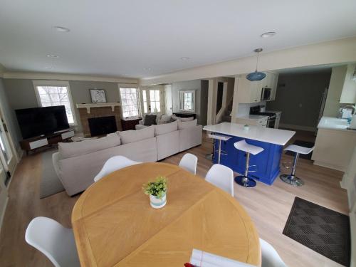 a living room with a table and a couch at Cheerful 3-bedroom in Wayzata on private wooded lot in Wayzata