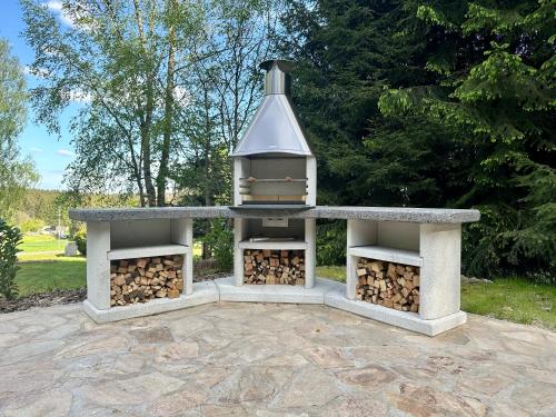 a outdoor oven with a pile of fire wood at Chalupa Janovice in Rudník
