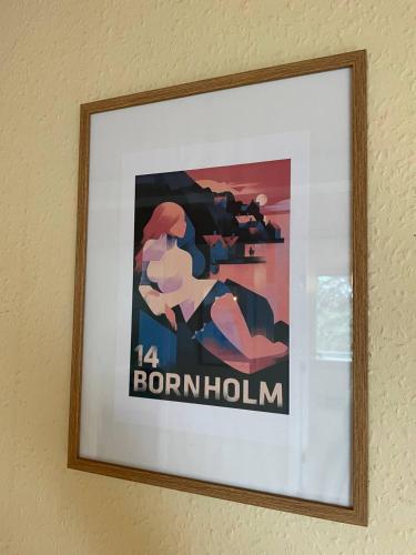 a framed picture of a woman on a wall at Homestay in charming house on the countryside in Rønne