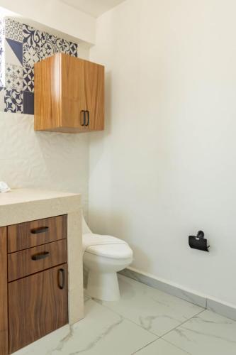 a bathroom with a toilet and a sink at Casa Nawalli Puerto Vallarta Boutique Hotel - Adults Only in Puerto Vallarta
