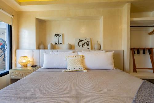 a bedroom with a large bed with white pillows at Casa Nawalli Puerto Vallarta Boutique Hotel - Adults Only in Puerto Vallarta