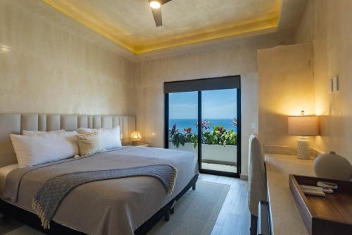 a bedroom with a bed with a view of the ocean at Casa Nawalli Puerto Vallarta Boutique Hotel - Adults Only in Puerto Vallarta