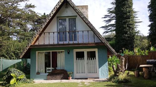 una pequeña casa con techo de gambrel en Cabaña,Chalet Alpino Bosques de Peralta Ramos en Mar del Plata