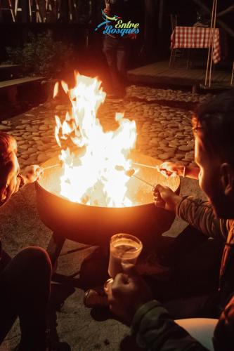 a group of people sitting around a fire pit at Entrebosques in Santa Elena
