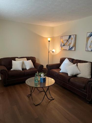 a living room with two couches and a coffee table at Charming 3BR 1.5BA Cozy Haven in Rome
