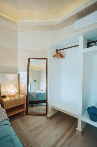 a living room with a mirror and a bed at Casa Nawalli Puerto Vallarta Boutique Hotel - Adults Only in Puerto Vallarta